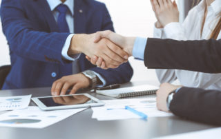 Man shaking hand accepting business deal