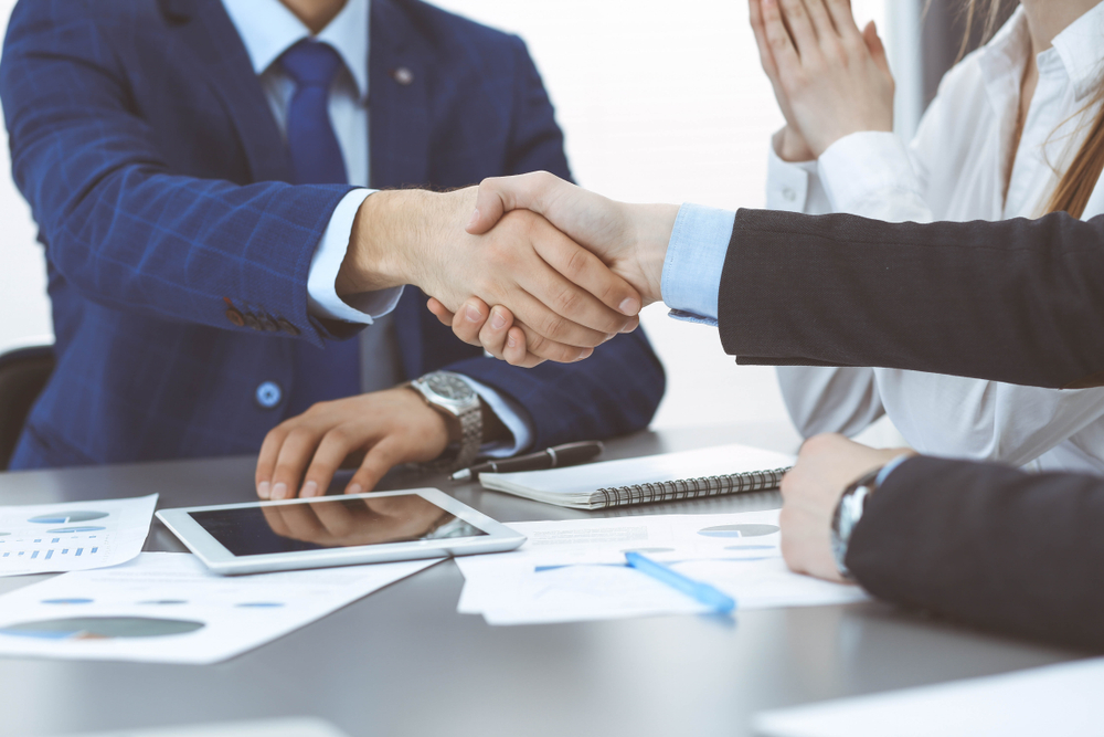 Man shaking hand accepting business deal